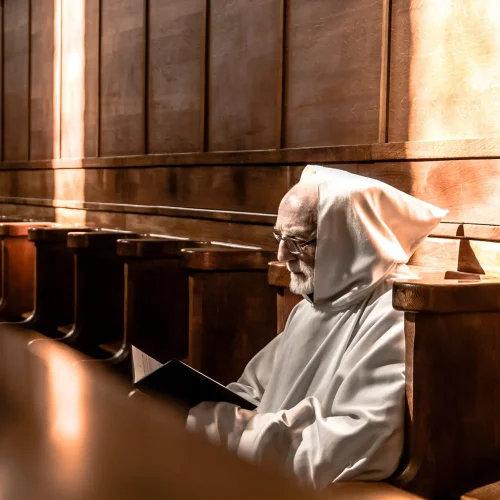Monk of Mount St Bernard Abbey in Chapel reading scripture